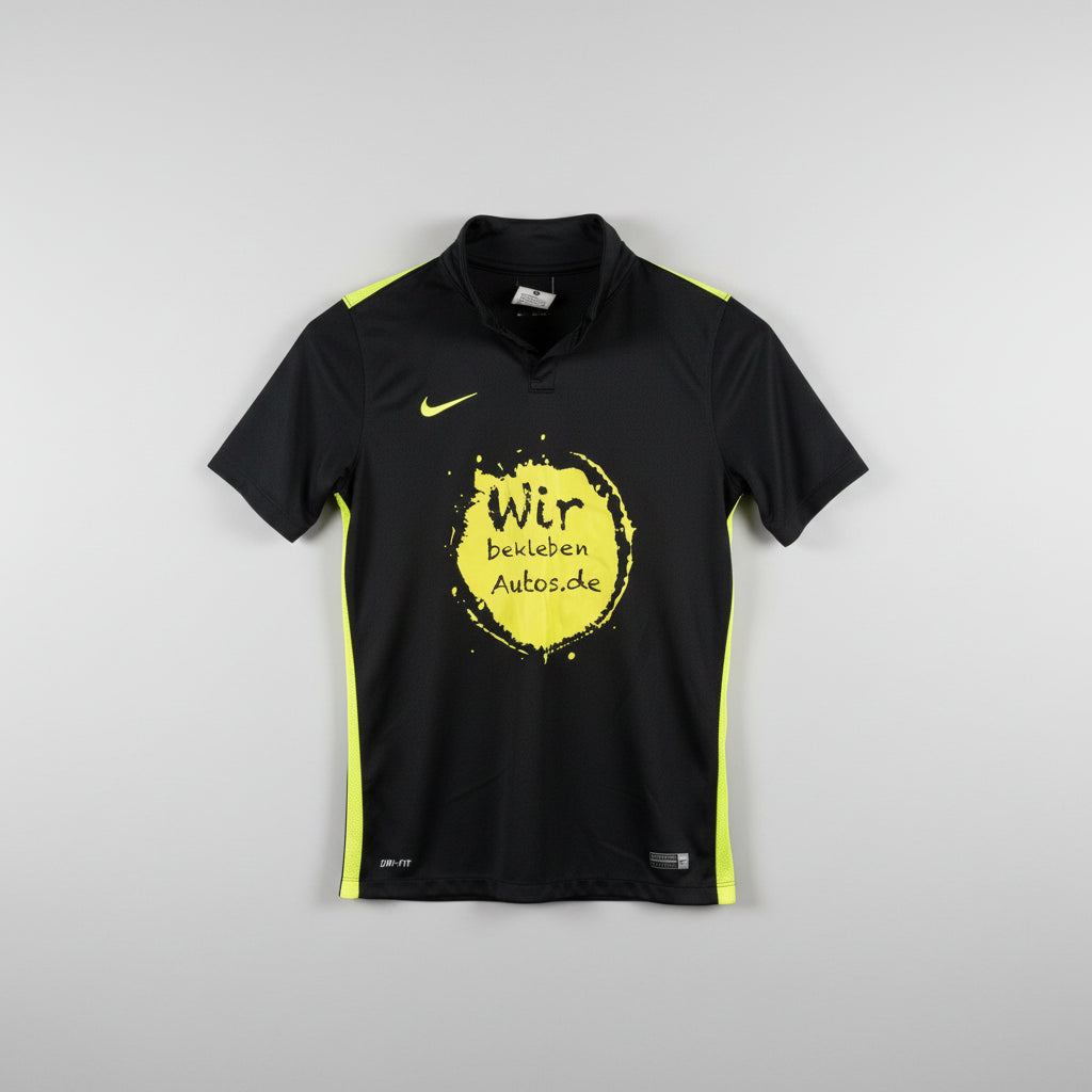 Black t-shirt with yellow text and logo on a hanger against a white wall.