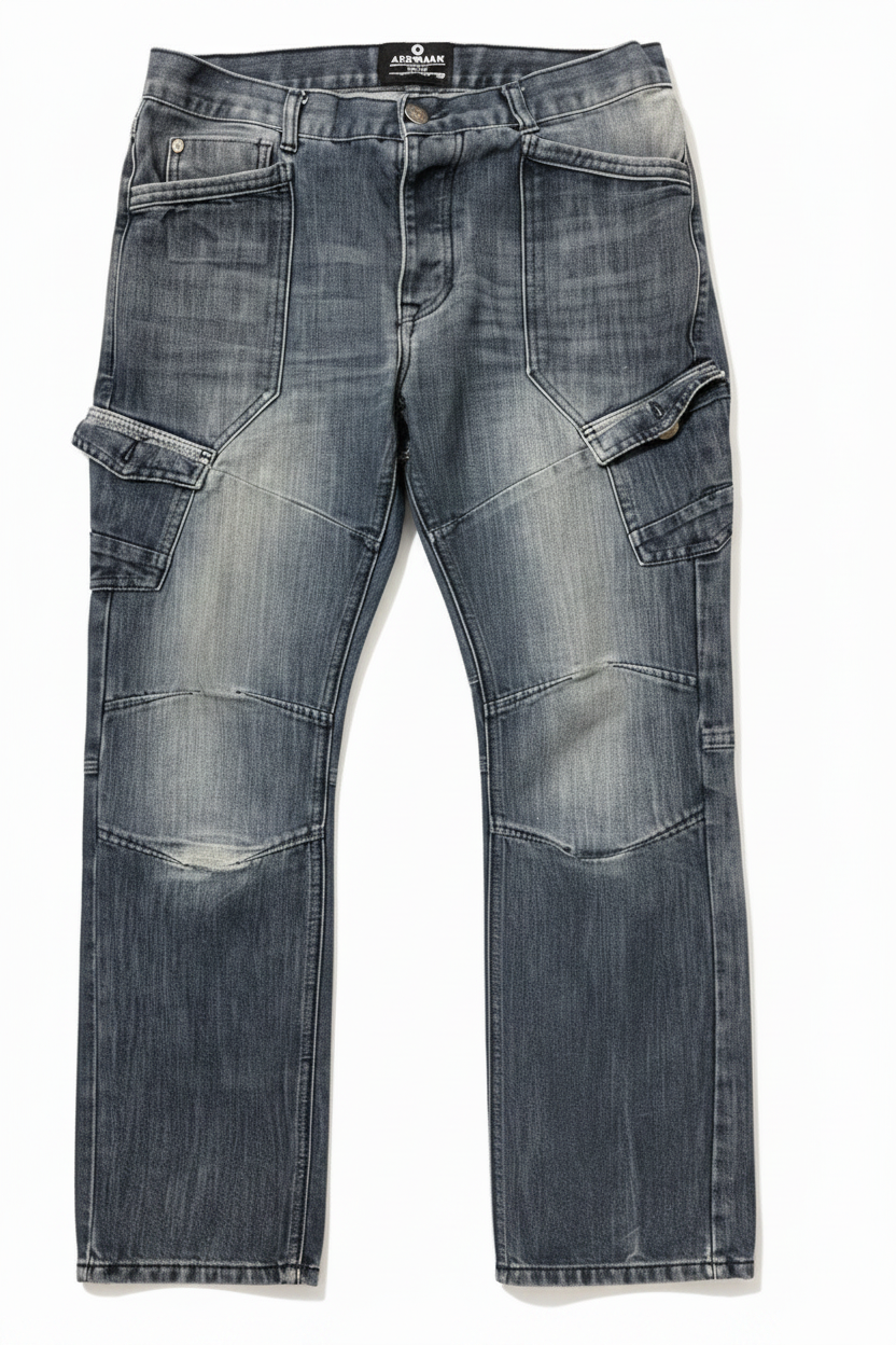 A pair of dark blue denim cargo jeans with a heavily faded, washed finish,