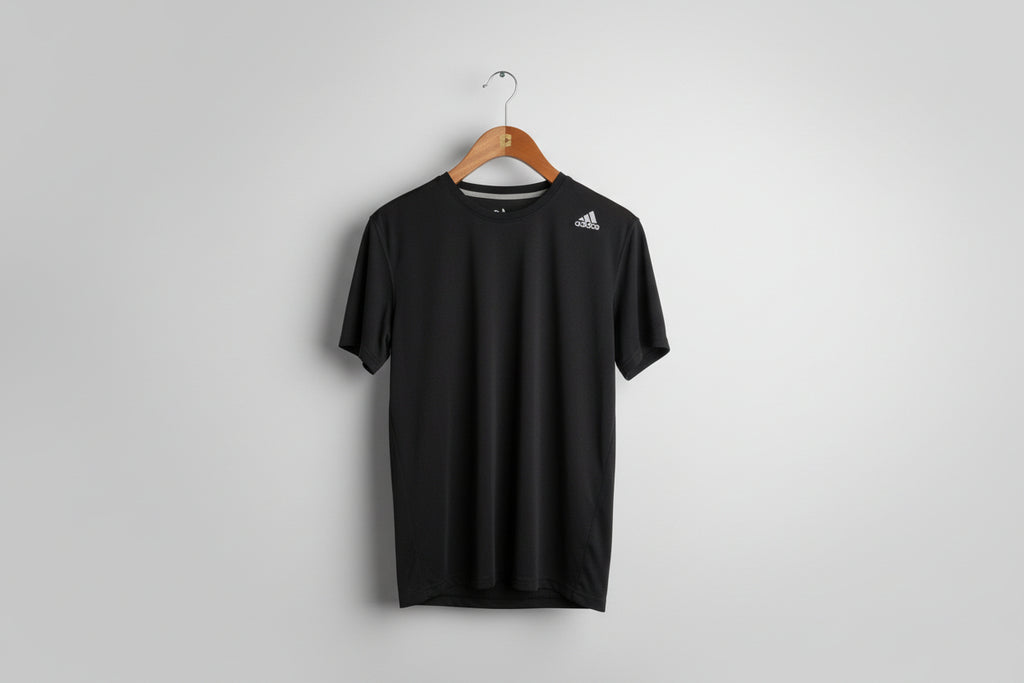 vintage black Adidas training t-shirt. Size L SKU 7345 .SKU 7344 . Price: €15. Material:     The fabric is a lightweight 100%  polyester double-knit, featuring moisture-wicking technology for high-intensity activity. 
